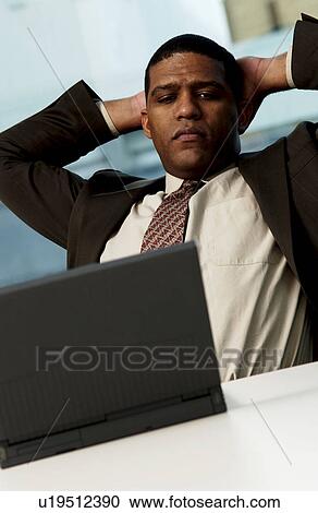 Stock Image - Man working on laptop . Fotosearch