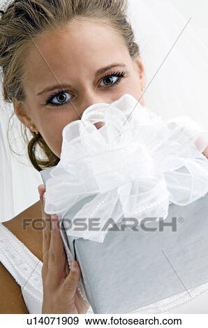 Bride holding gift View Large Photo Image Stock Photo - Bride holding gift. Fotosearch