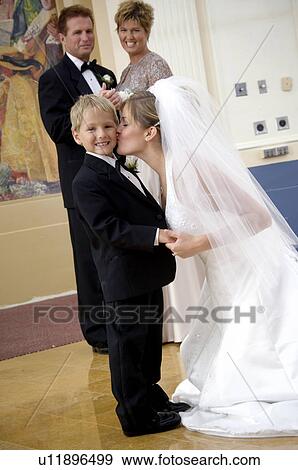 Bride kissing ring bearer View Large Photo Image Stock Photo - Bride kissing ring bearer. Fotosearch