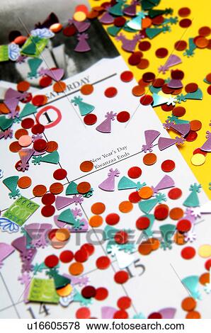 Stock Photo - Calendar with confetti and New Years Day circled. Fotosearch