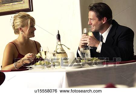 Stock Photograph - Couple eating dinner. Fotosearch