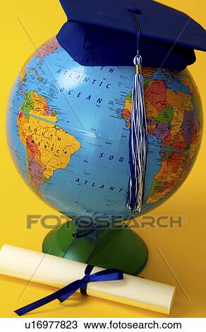Stock Image - Globe with graduation cap and diploma. Fotosearch