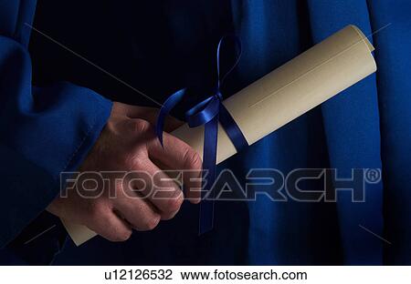 Stock Image - Graduate holding diploma. Fotosearch
