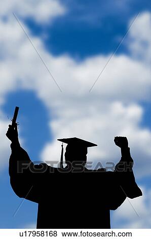 Stock Photo - Graduate with cloud background. Fotosearch