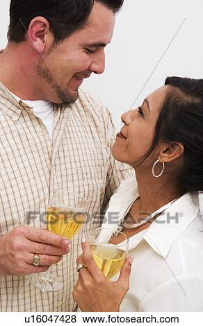 Hispanic couple making a champagne toast View Large Photo Image Stock Photo - Hispanic couple making a champagne toast. Fotosearch