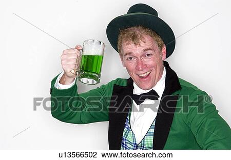 Man dressed as Leprechaun with mug of green beer View Large Photo Image Stock Image - Man dressed as Leprechaun with mug of green beer. Fotosearch