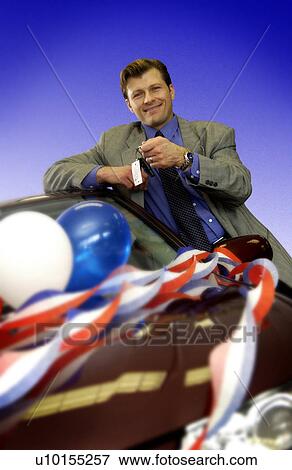 Stock Photo - Man leaning on new car. Fotosearch