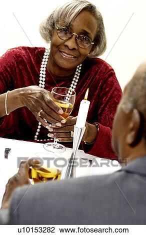 Stock Image - Senior couple having a romantic meal. Fotosearch