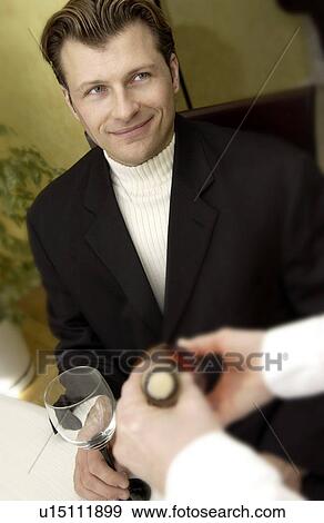 Stock Photo - Waiter serving wine. Fotosearch