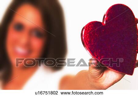 Stock Image - Woman holding heart box. Fotosearch