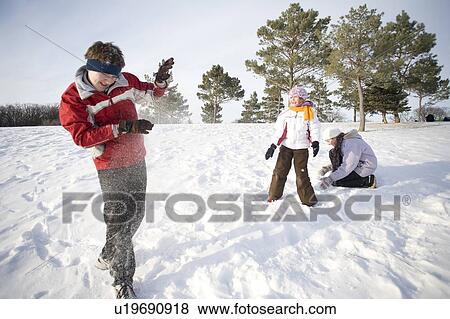 3 kids (14, 13, and 9) throw snow at each other, Winnipeg, Canada View Large Photo Image Stock Photo - 3 kids (14, 13, and 9) throw snow at each other, Winnipeg, Canada. Fotosearch