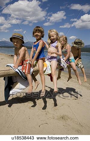 Stock Image - Children playing on beach on Lake Koocanusa in the East Kootenays near Fernie, British Columbia, Canada. Fotosearch