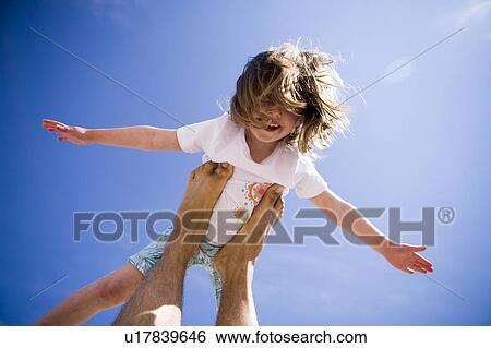 Girl (4) does "airplane" balancing on adult's feet, Grand Beach, Manitoba, Canada View Large Photo Image Stock Photograph - Girl (4) does "airplane" balancing on adult's feet, Grand Beach, Manitoba, Canada. Fotosearch