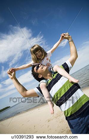Girl (4) rides on man's shoulders, Grand Beach Provincial Park, Manitoba, Canada View Large Photo Image Stock Image - Girl (4) rides on man's shoulders, Grand Beach Provincial Park, Manitoba, Canada. Fotosearch