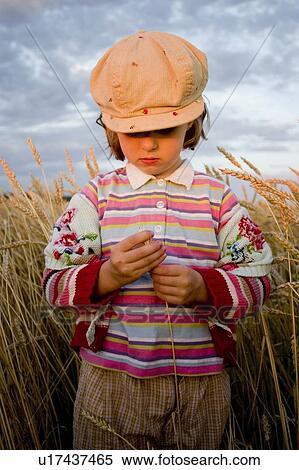 Stock Photography - Girl - 5 years old in the field, Manitoba, Canada. Fotosearch