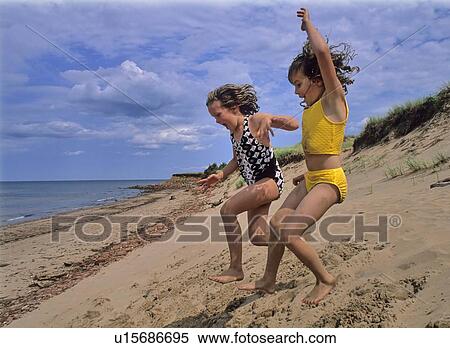 Kids jump from sand dune, summer day, Prince Edward Island, Canada View Large Photo Image Stock Photography - Kids jump from sand dune, summer day, Prince Edward Island, Canada. Fotosearch