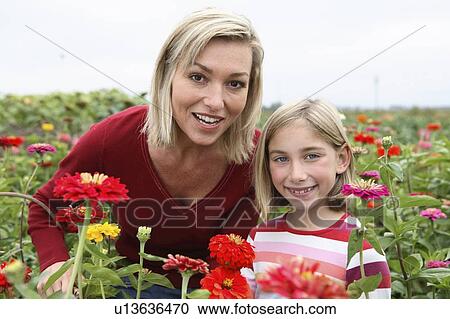 Mother and daughter in a field of organic flowers, Ladner, British Columbia, Canada View Large Photo Image Stock Image - Mother and daughter in a field of organic flowers, Ladner, British Columbia, Canada. Fotosearch