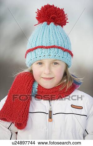Picture - Outdoor winter portrait of 9 year old girl in colourful woolen hat, Winnipeg, Canada. Fotosearch