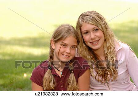 Portrait of young girls on grass, Regina, Saskatchewan View Large Photo Image Stock Photo - Portrait of young girls on grass, Regina, Saskatchewan. Fotosearch