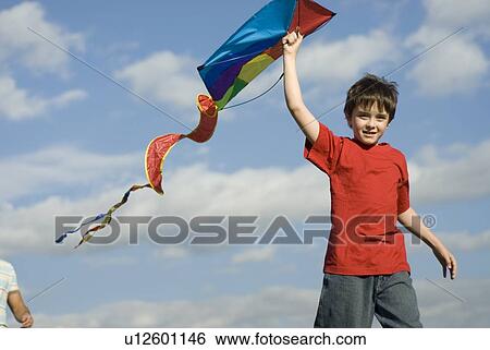 Six year old boy holding kite over head, Assiniboine Park, Winnipeg, Canada View Large Photo Image Stock Photograph - Six year old boy holding kite over head, Assiniboine Park, Winnipeg, Canada. Fotosearch