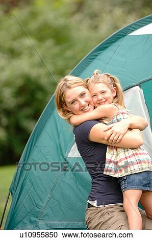 Stock Image - Woman and child hugging in front of tent, Regina, Saskatchewan. Fotosearch