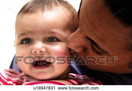 Stock Image - African American father holding daughter. Fotosearch