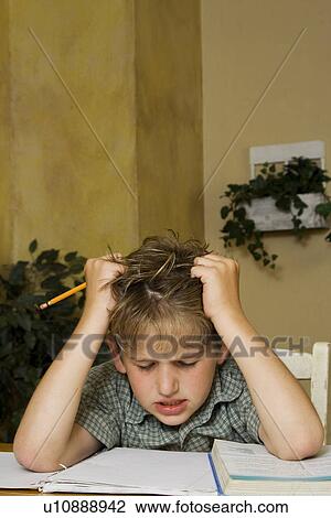 Stock Image - Boy doing homework. Fotosearch