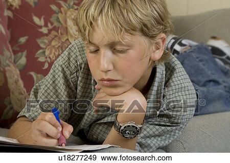 Stock Photo - Boy doing homework. Fotosearch