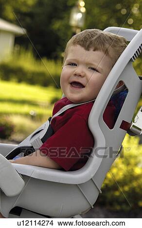 Picture - Boy in bicycle seat. Fotosearch