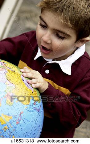 Boy looking at globe View Large Photo Image Stock Photo - Boy looking at globe. Fotosearch