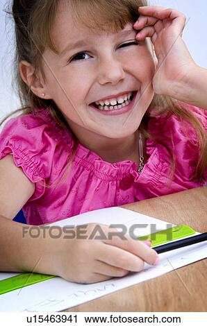 Stock Image - Girl doing homework. Fotosearch
