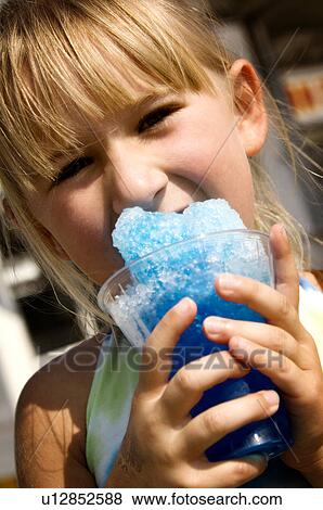 Girl eating carnival food View Large Photo Image Stock Photo - Girl eating carnival food. Fotosearch