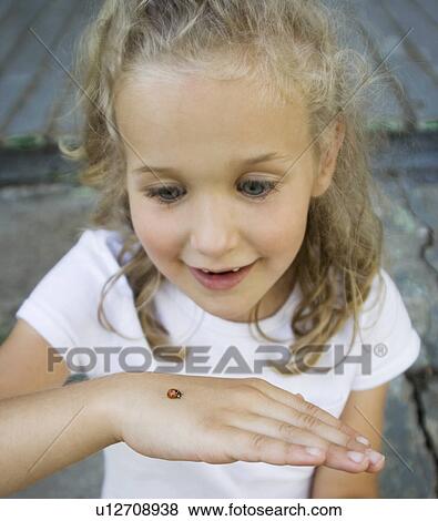 Girl holding ladybug View Large Photo Image Stock Photo - Girl holding ladybug. Fotosearch