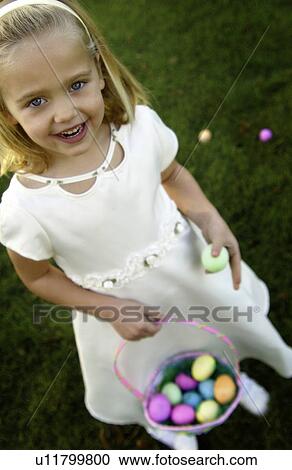 Stock Image - Girl hunting Easter eggs. Fotosearch