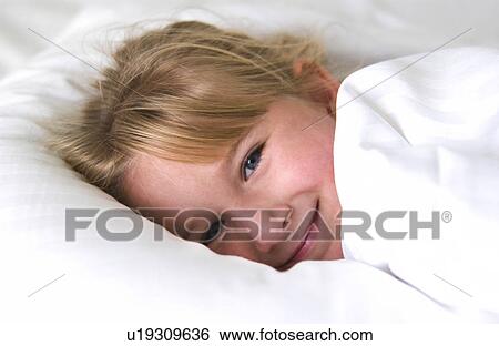 Girl lying in bed View Large Photo Image Stock Photograph - Girl lying in bed. Fotosearch