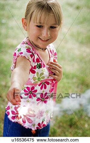 Girl with a sparkler View Large Photo Image Stock Photography - Girl with a sparkler. Fotosearch