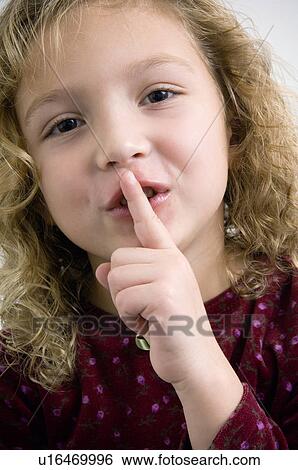 Portrait making quiet sign View Large Photo Image Stock Photograph - Portrait making quiet sign. Fotosearch