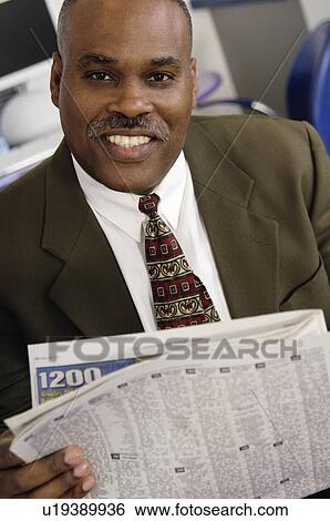 African American businessman reading newspaper View Large Photo Image Stock Photograph - African American businessman reading newspaper. Fotosearch