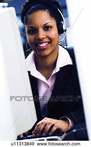 Stock Photo - African American woman at computer. Fotosearch