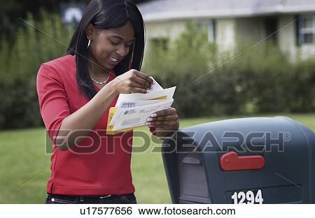 African American woman getting mail from mailbox View Large Photo Image Stock Photograph - African American woman getting mail from mailbox. Fotosearch