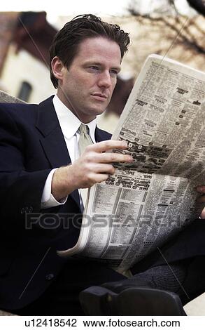 Stock Image - Businessman reading newspaper. Fotosearch