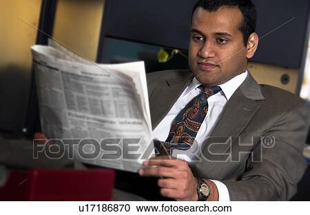 Businessman reading newspaper View Large Photo Image Stock Image - Businessman reading newspaper. Fotosearch