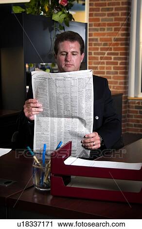 Stock Image - Businessman reading newspaper. Fotosearch