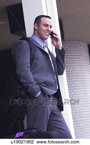 Stock Image - Businessman talking on cell phone. Fotosearch