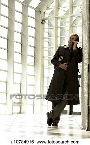 Stock Photograph - Businessman talking on cell phone. Fotosearch