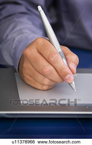 Businessman writing on computer notepad View Large Photo Image Stock Photograph - Businessman writing on computer notepad. Fotosearch