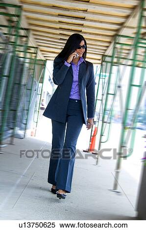 Stock Photography - Businesswoman on cell phone. Fotosearch