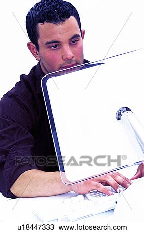 Stock Image - Hispanic man working at computer . Fotosearch