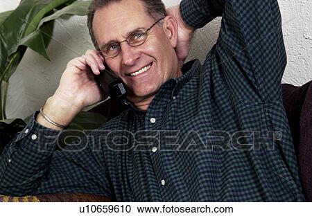 Stock Image - Older man talking on phone. Fotosearch