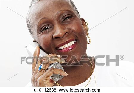 Stock Photo - Older woman talking on cordless phone. Fotosearch